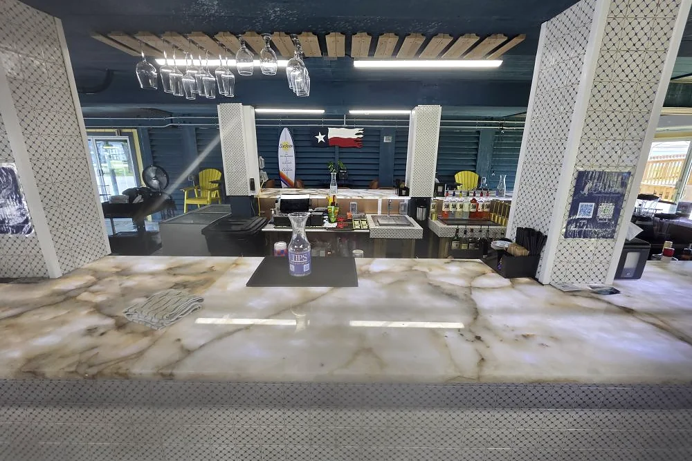 Completed commercial interior fit-out with polished floors, exposed timber ceiling and tiled columns