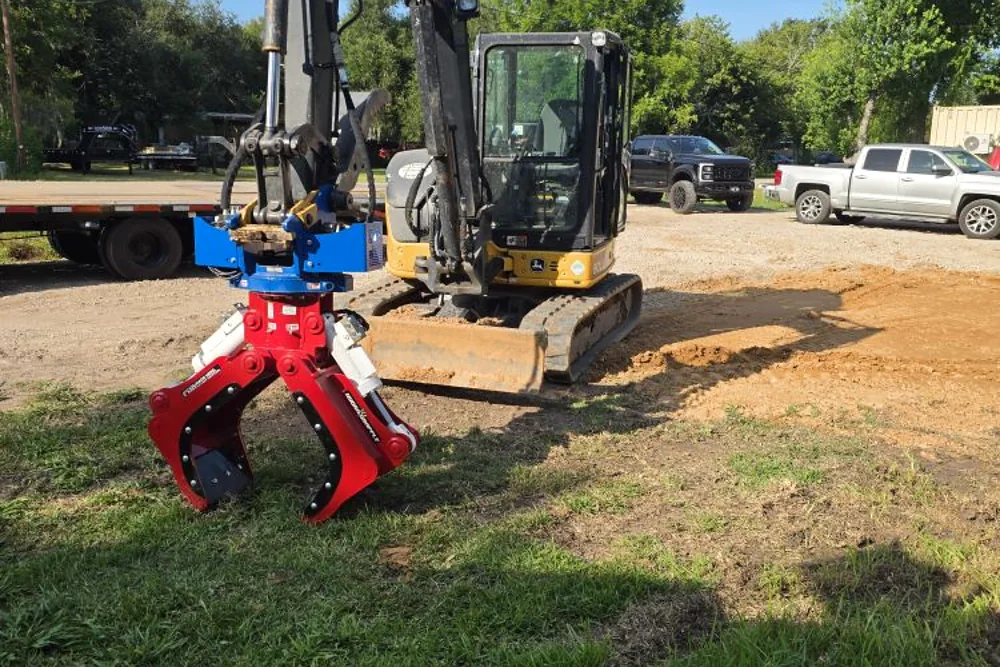 Excavator fitted with a hydraulic pile driving attachment on a Texas jobsite