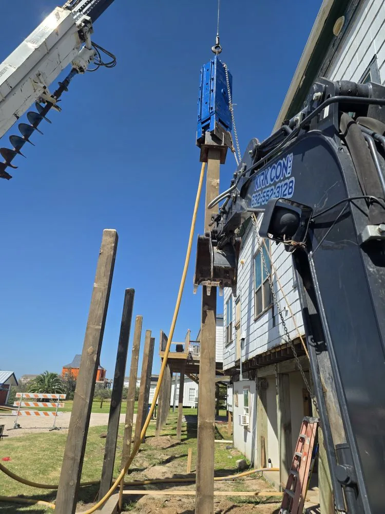Timber piling being driven with a hydraulic hammer
