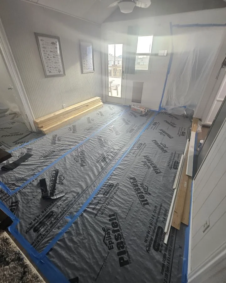 Interior room fully masked and floor-protected ahead of finishing work