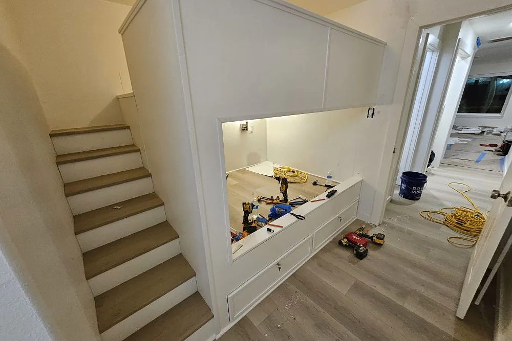 Finished staircase and custom white built-in millwork in a remodeled home