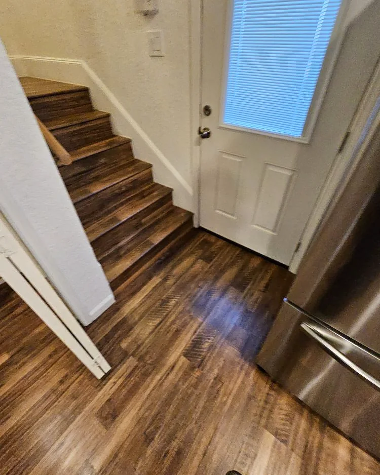 New hardwood flooring and stair treads in a completed interior renovation